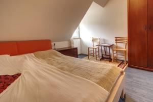 a bedroom with a bed and a table and chairs at EcoFit Povlen in Valjevo