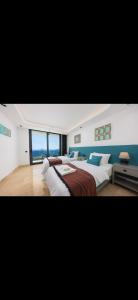 two beds in a bedroom with a view of the ocean at Villa turquoise in Kalkan