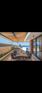 a dining room with a table and chairs and the ocean at Villa turquoise in Kalkan