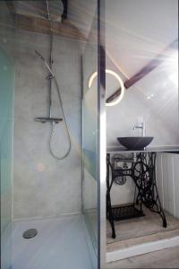 a bathroom with a shower with a sink and a table at Holidayhouse Balie in Bruges