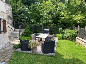 a patio with a table and chairs in the grass at Villa Markisa in Rukavac