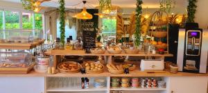 a bakery with baskets of bread and food on display at Hotel Tennis International in Cap d'Agde