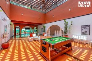 a large living room with a pool table in it at The Estate Villa Where Luxury Meets Serenity in Suntikoppa