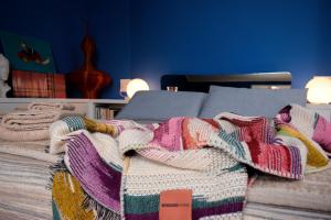 a bed with a colorful blanket on top of it at Villa Willa Walla in Golasecca