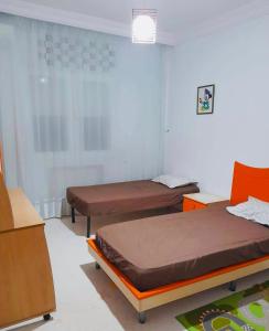 a room with two beds in a room at Dream Appartement Monastir in Monastir
