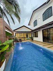 a swimming pool in front of a house at LYL Ipoh Garden Private Pool Villa-18pax 5BR in Ipoh