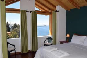 a bedroom with a bed and a large window at Casa de la Luna in Comunidad Yumani