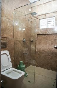 un bagno con wc e doccia in vetro di Skyscape Resort a Kaniyāmbetta Altre 2 foto