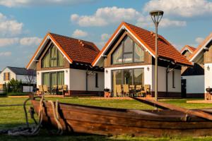 a house with a wooden boat in front of it at Kaszubia in Jastrzębia Góra
