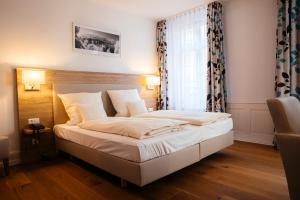 Postel nebo postele na pokoji v ubytování Hotel Perkeo