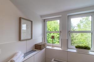 a bathroom with two windows and a mirror at ErzGlück Apartment I WLAN I Küche I Stellplatz I 4P in Neuwelt +18 photos