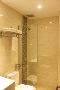 a bathroom with a shower and a toilet and a sink at NU Hotel @ KL Sentral in Kuala Lumpur