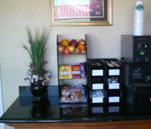 a counter with a refrigerator with fruits and food on it at North Bay Inn in San Rafael