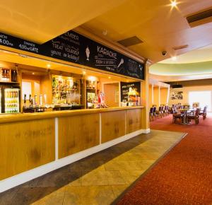 a bar in a restaurant with tables and chairs at Caravan-Blackpool-FamilyFriendly-Activities in Fleetwood