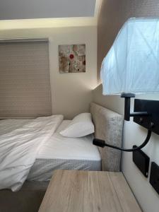 a room with a bed and a desk with a lamp at Menzal-202 in Al Madinah