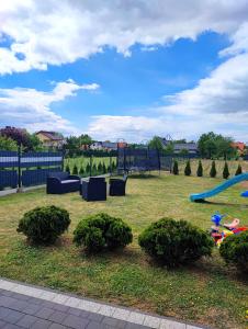 a park with a playground with a slide at Apartamenty NOVA - BLISKO ENERGYLANDII in Zator