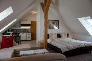 a bedroom with a bed and a living room at Gästehaus Siebert in Lobbe