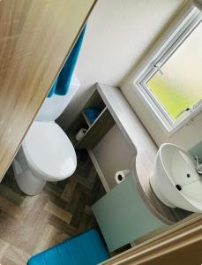 a bathroom with a white toilet and a sink at Caravan-Blackpool-FamilyFriendly-Activities in Fleetwood