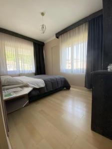 A bed or beds in a room at EVİM APART HOTEL