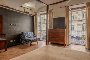 a bedroom with a dresser and a chair and a window at lovingenoa Natural - Light in Genoa