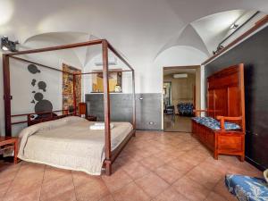 a bedroom with a canopy bed in a room at lovingenoa Natural - Light in Genoa