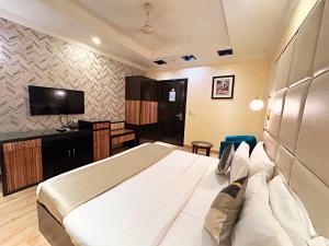 a hotel room with a bed and a television at The Oakland plaza - Nehru Place by Orion Hotels in New Delhi