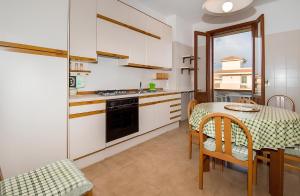 a kitchen and dining room with a table and chairs at Vista Mare Lido Avola in Avola