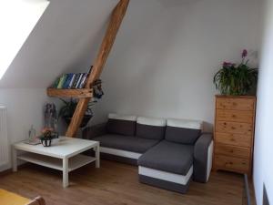 a living room with a couch and a table at Ráj za humny in Černé Voděrady