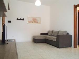 a living room with a couch and a tv at KAI Apartment in Villa Rosa
