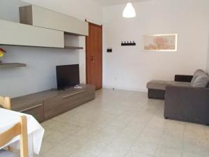a living room with a couch and a flat screen tv at KAI Apartment in Villa Rosa