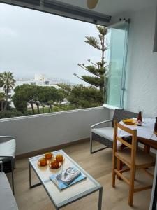 a living room with a table and a large window at Sea and Mountains in Gran Alacant