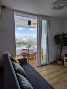 a living room with a couch and a view of a table at Sea and Mountains in Gran Alacant