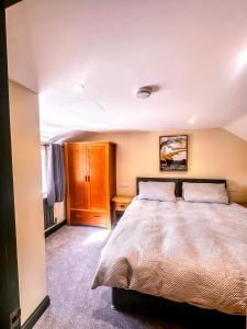 a bedroom with a large bed in a room at The Stables in Selby