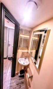 a bathroom with a sink and a mirror at The Stables in Selby +20 photos