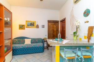 a living room with a couch and a table at Smeraldo Beach in Santa Teresa Gallura