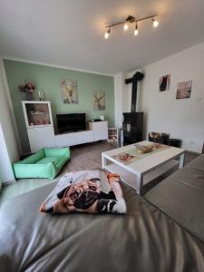 a living room with a large picture of a person laying on a bed at Ferienwohnung Hundenest im Altmühltal in Kinding