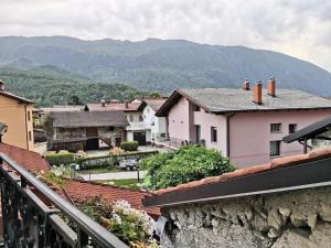 a view of a town with mountains in the background at Sobe Pri Olivi in Kobarid