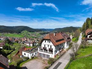 a large white house with a red roof at Gästehaus Talblick Baiersbronn in Baiersbronn