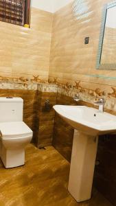 a bathroom with a toilet and a sink at catherine villa in Ja-Ela