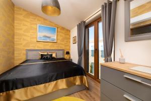 a bedroom with a black and gold bed and a window at Villa Andante Malinska in Malinska +30 photos