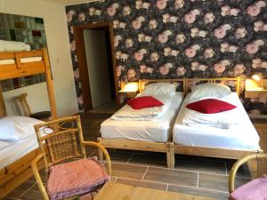 a bedroom with two bunk beds and two chairs at B&B Waldcafe in Altenau