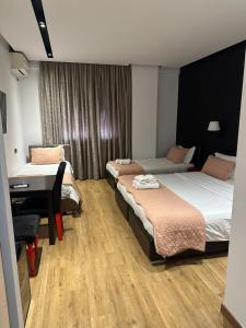 Postel nebo postele na pokoji v ubytování Aurelis Hotel