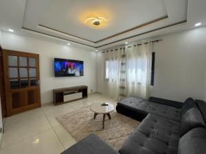 a living room with a couch and a table at Koivogui in Dakan