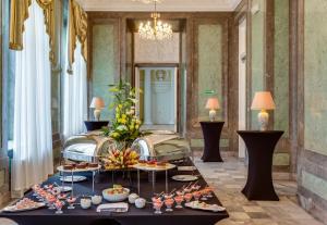a buffet of food on a table in a room at Hotel Bellotto in Warsaw