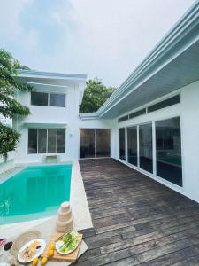a villa with a swimming pool and a house at Private Beach Villa in Zambales in Sampong