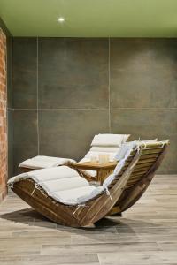 a group of lounging chairs in a room at Hôtel Restaurant AKENA Molinges - La Brocatelle in Saint-Claude