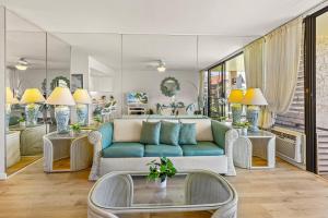 a living room with a couch and a table at Papakea C209 in Honokowai