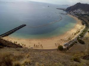 a group of people on a beach near the water at MasRelaxTenerife in La Laguna