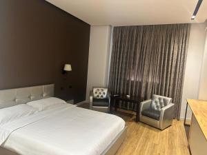 Postel nebo postele na pokoji v ubytování Aurelis Hotel