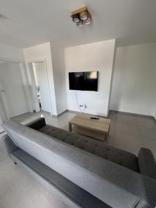 a living room with a couch and a flat screen tv at GM Ferienwohnung 1 in Ochtrup